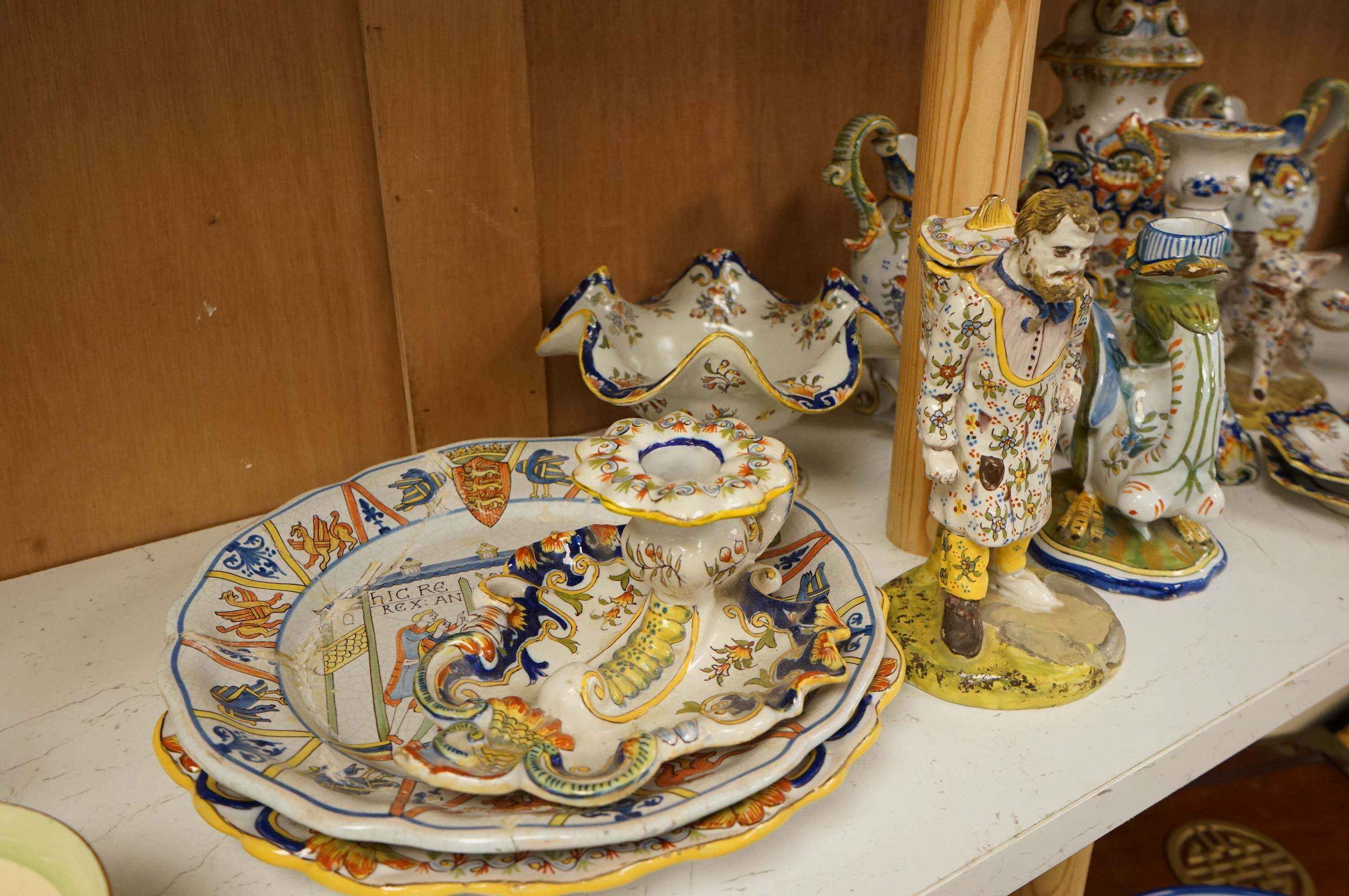 A collection of early 20th century French faience pieces to include a pair of salts in the form of pigs and candlesticks, largest 27cm high